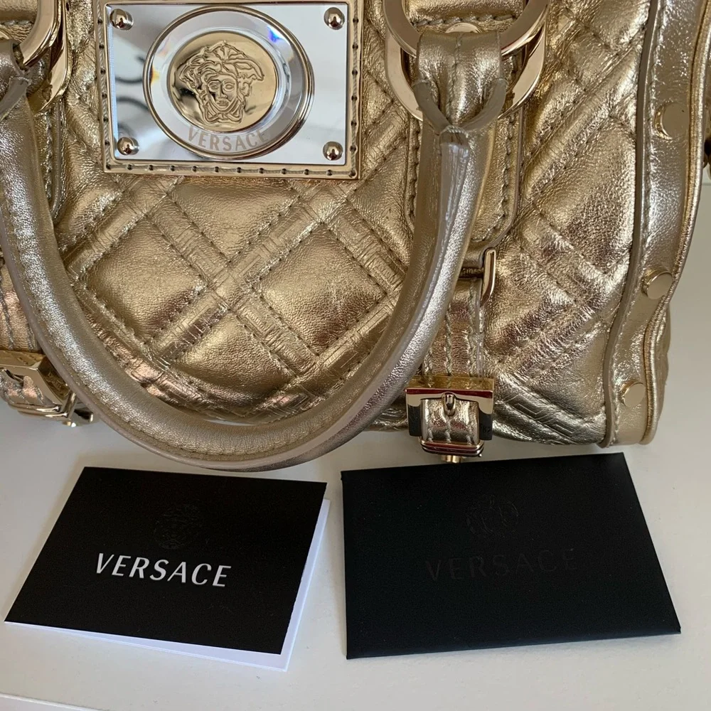 Hold Versace gold quilted handbag